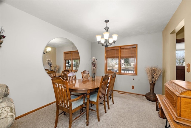 dining space with light carpet, a chandelier, and a wealth of natural light