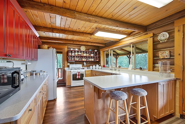 kitchen with plenty of natural light, light countertops, white range with gas cooktop, and a peninsula