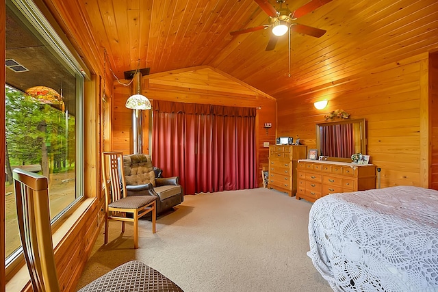 carpeted bedroom featuring lofted ceiling, wood ceiling, wooden walls, and visible vents