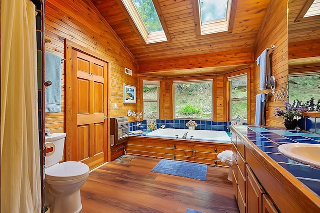 full bath featuring heating unit, visible vents, wooden walls, wood finished floors, and vaulted ceiling with skylight