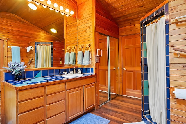 full bath with lofted ceiling, wood ceiling, wooden walls, and wood finished floors