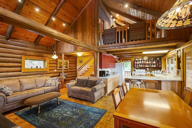 living room with stairs, high vaulted ceiling, beamed ceiling, and wooden ceiling