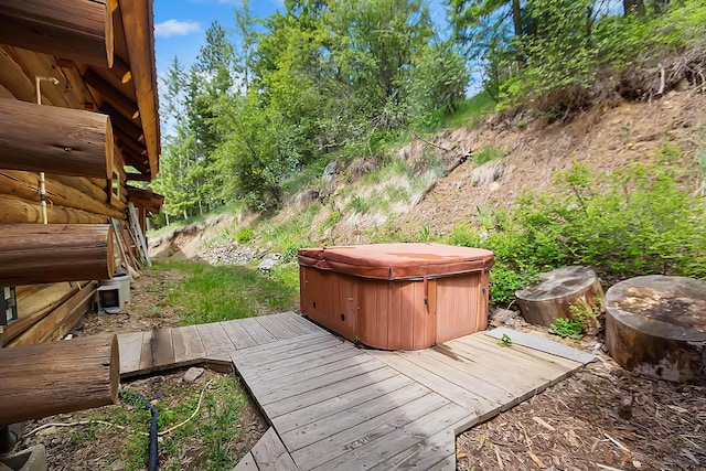 wooden deck with a hot tub