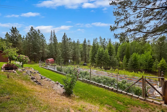 view of property's community featuring a garden and a yard