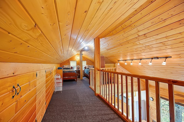 additional living space with wood ceiling, vaulted ceiling, dark carpet, and wooden walls