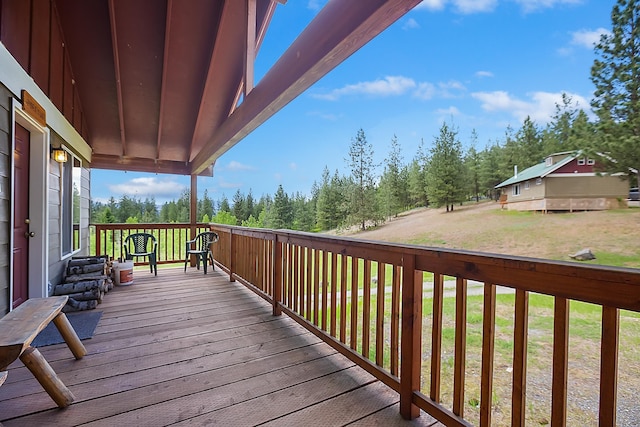 wooden deck featuring a lawn