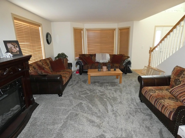 living room with carpet and stairway