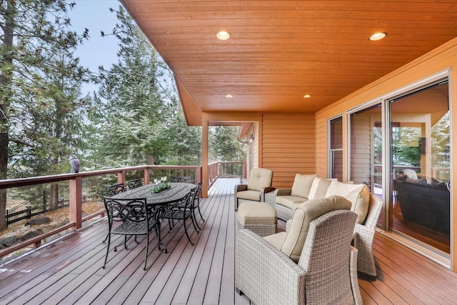 wooden deck featuring outdoor dining area and an outdoor hangout area