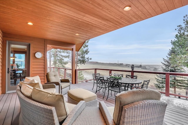 wooden deck featuring a water view and outdoor dining area