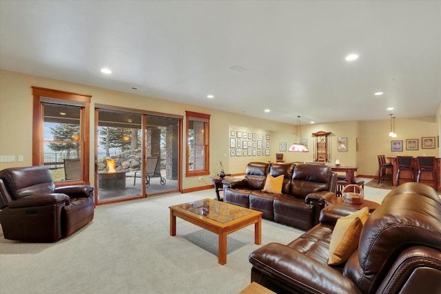 living room featuring recessed lighting, light carpet, visible vents, and baseboards