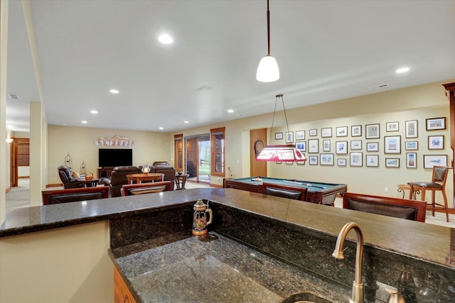 kitchen with open floor plan, hanging light fixtures, and recessed lighting