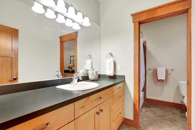 full bathroom with tile patterned flooring, toilet, vanity, baseboards, and shower / bath combo with shower curtain