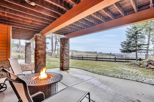 view of patio / terrace featuring an outdoor fire pit and fence