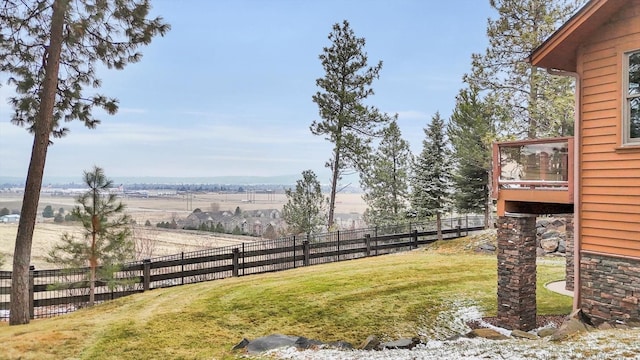 view of yard featuring a rural view and fence