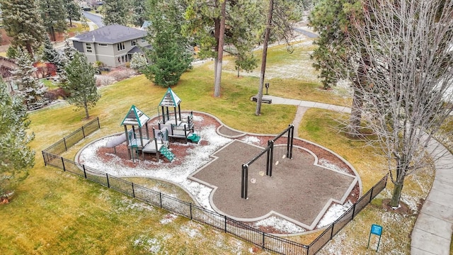 view of community featuring playground community, a lawn, and fence