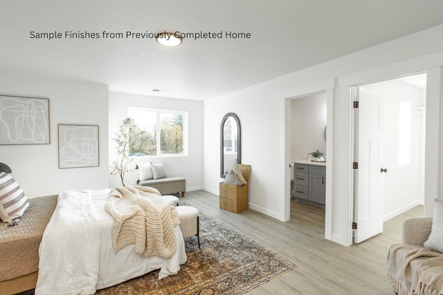 bedroom featuring visible vents, ensuite bath, light wood-style flooring, and baseboards