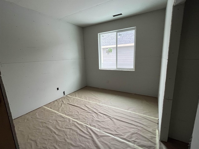 unfurnished room with visible vents