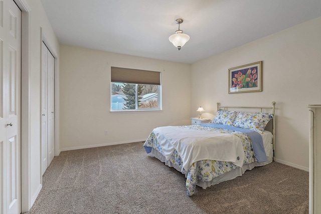 carpeted bedroom with baseboards and a closet