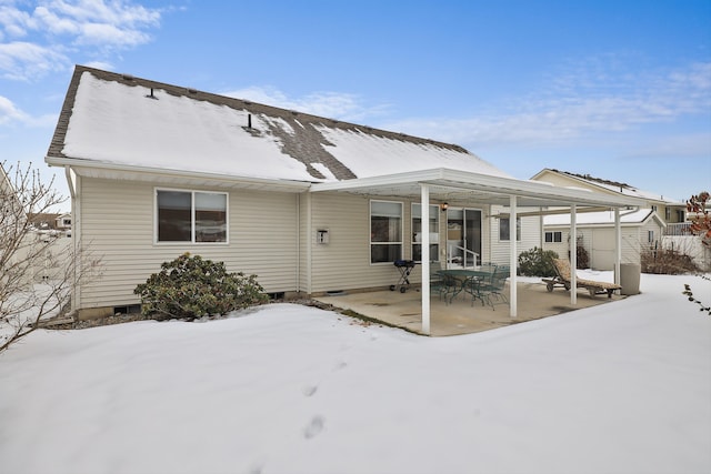 snow covered property featuring a patio area