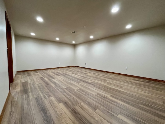 empty room featuring recessed lighting, visible vents, light wood-style flooring, and baseboards