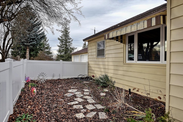 view of side of home with a fenced backyard