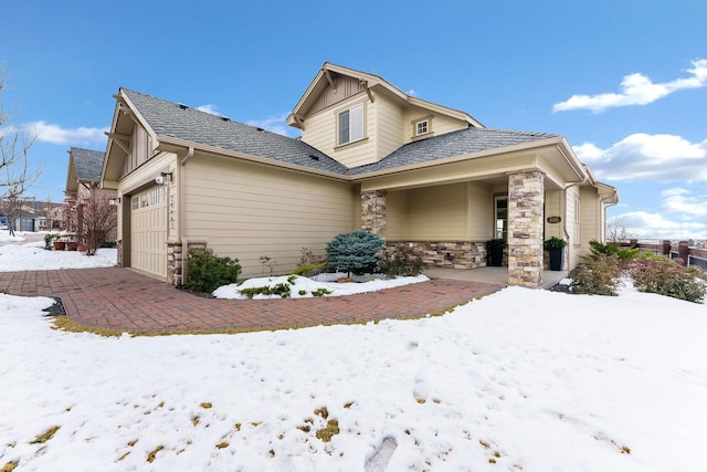 view of front of home featuring a garage and stone siding