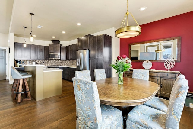 dining area featuring dark wood finished floors and recessed lighting