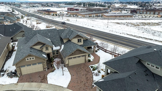 snowy aerial view with a residential view