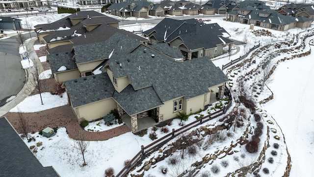 snowy aerial view featuring a residential view