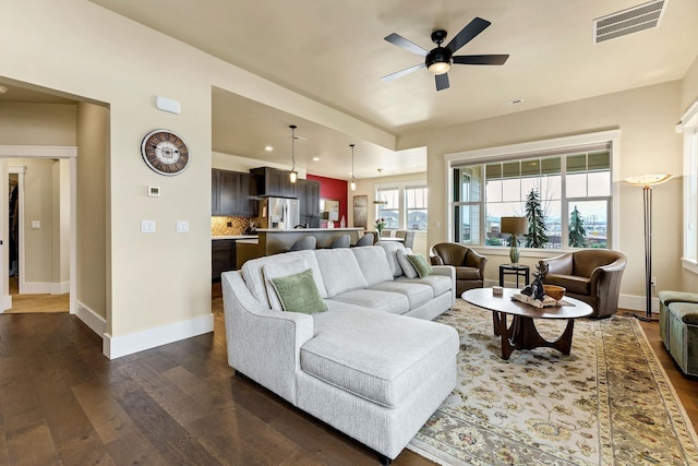 living room featuring baseboards, visible vents, dark wood-style floors, ceiling fan, and recessed lighting