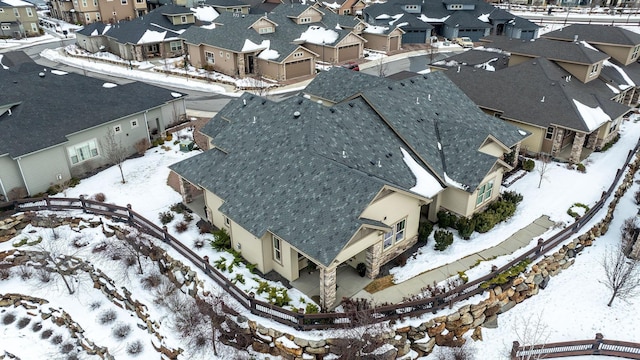 snowy aerial view with a residential view