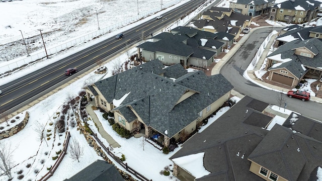 snowy aerial view featuring a residential view