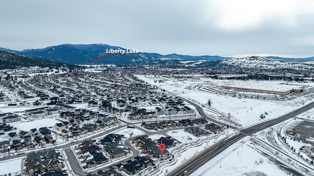 snowy aerial view featuring a mountain view