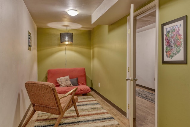 living area featuring light wood-style floors and baseboards