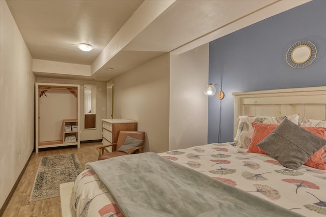 bedroom featuring light wood-style flooring and baseboards