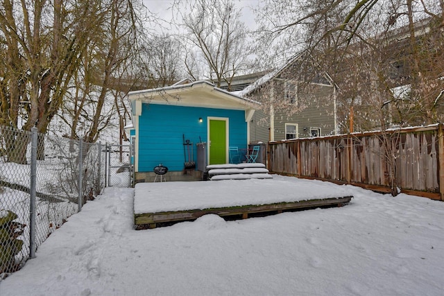 snow covered property featuring fence