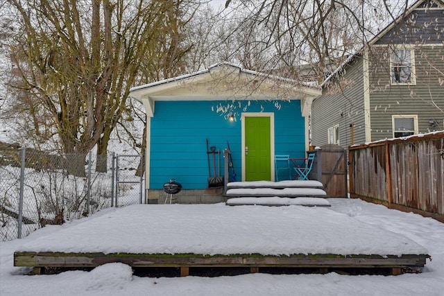 snow covered structure featuring fence