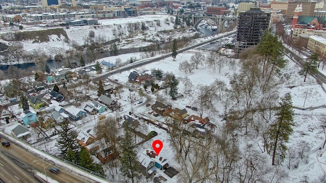 snowy aerial view featuring a city view