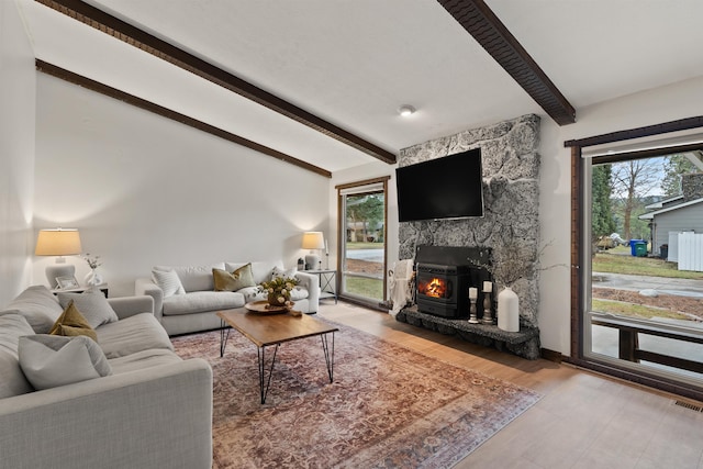 living room with lofted ceiling with beams and light wood finished floors