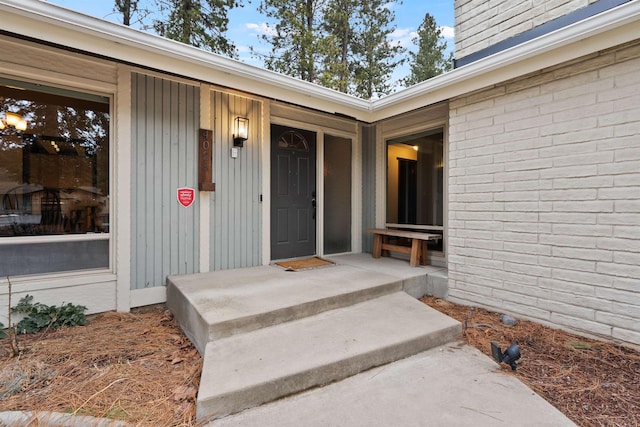 entrance to property featuring brick siding