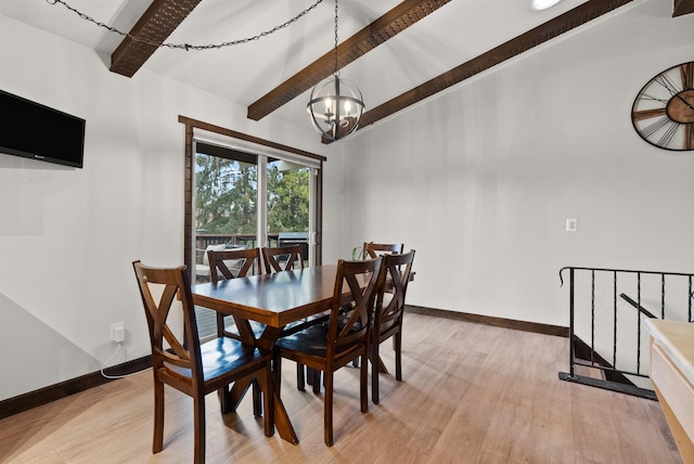 dining room with an inviting chandelier, baseboards, and light wood finished floors