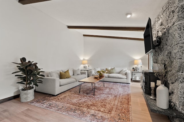 living room with vaulted ceiling with beams, baseboards, and wood finished floors