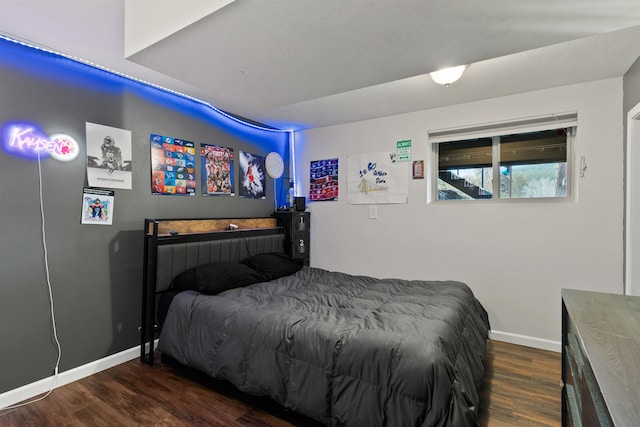 bedroom featuring dark wood-style floors and baseboards