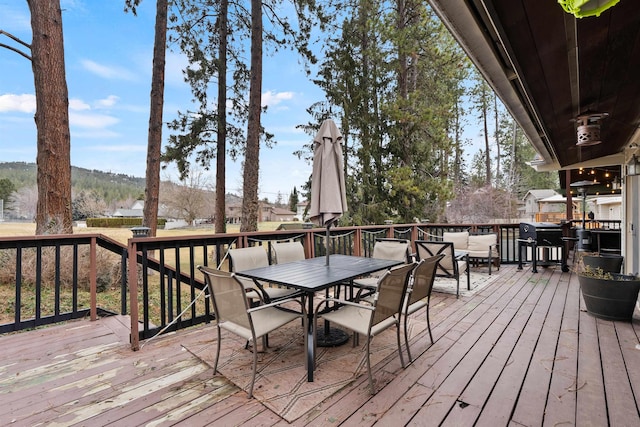 wooden deck with outdoor dining area