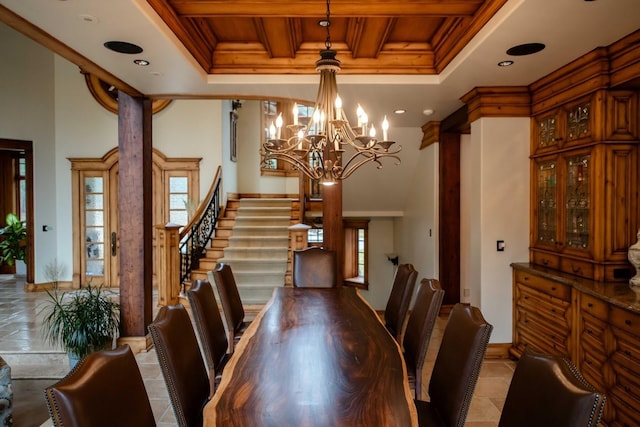 dining space featuring stairway, ornamental molding, a chandelier, beamed ceiling, and ornate columns