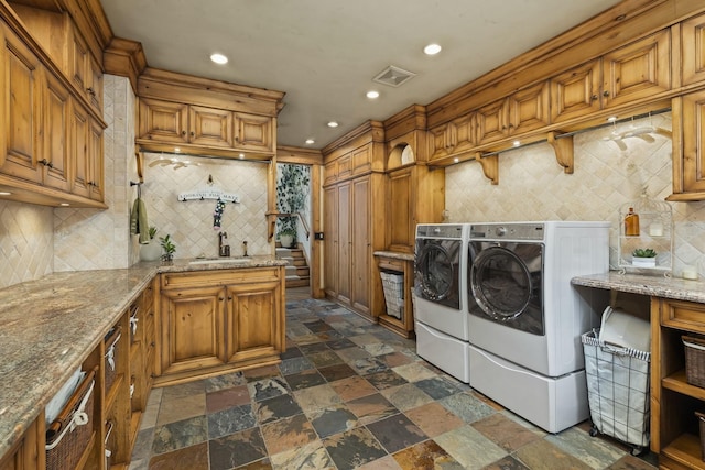 laundry room featuring cabinet space, visible vents, washing machine and clothes dryer, stone tile flooring, and recessed lighting