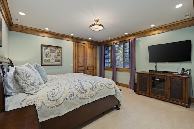 bedroom featuring recessed lighting, visible vents, light colored carpet, and ornamental molding