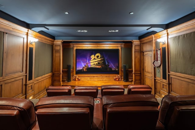 cinema room featuring a decorative wall and wooden walls