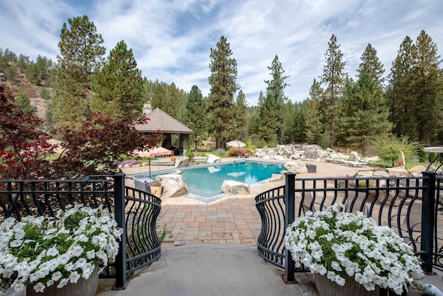 view of pool with a patio area, a fenced in pool, and a gazebo