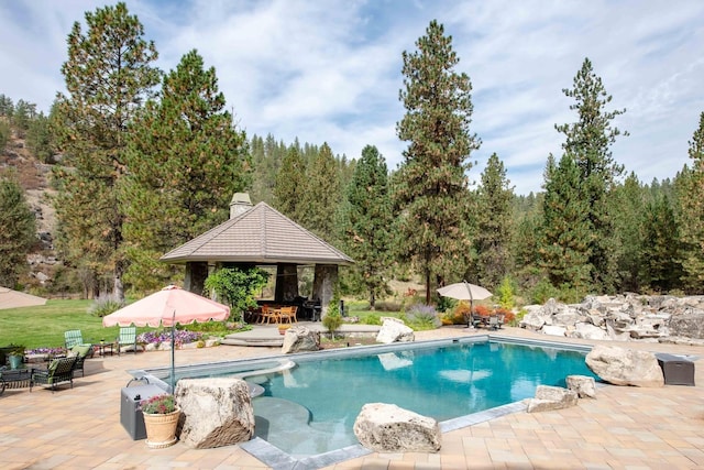 outdoor pool featuring a patio and a gazebo